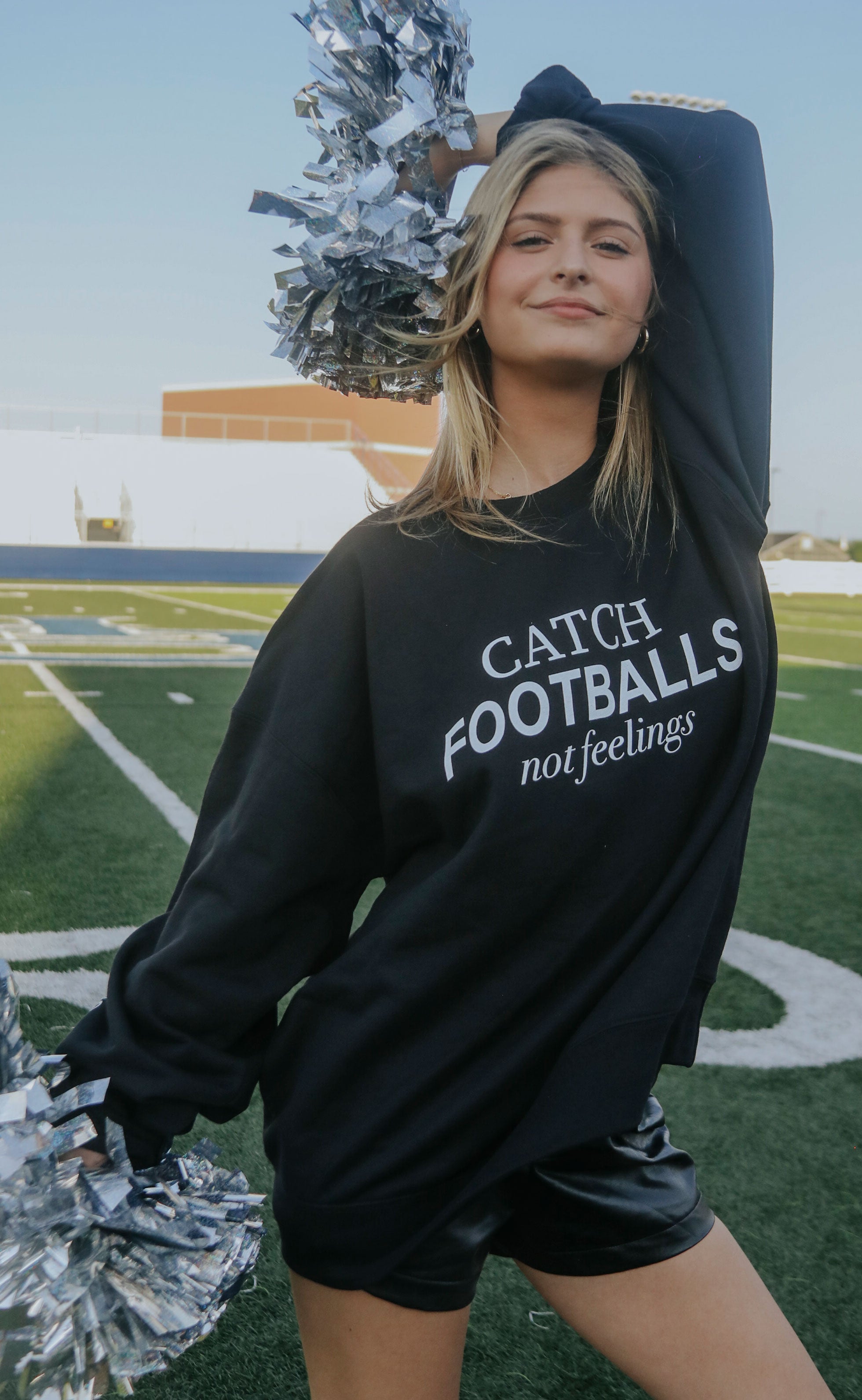 friday + saturday: catch footballs sweatshirt